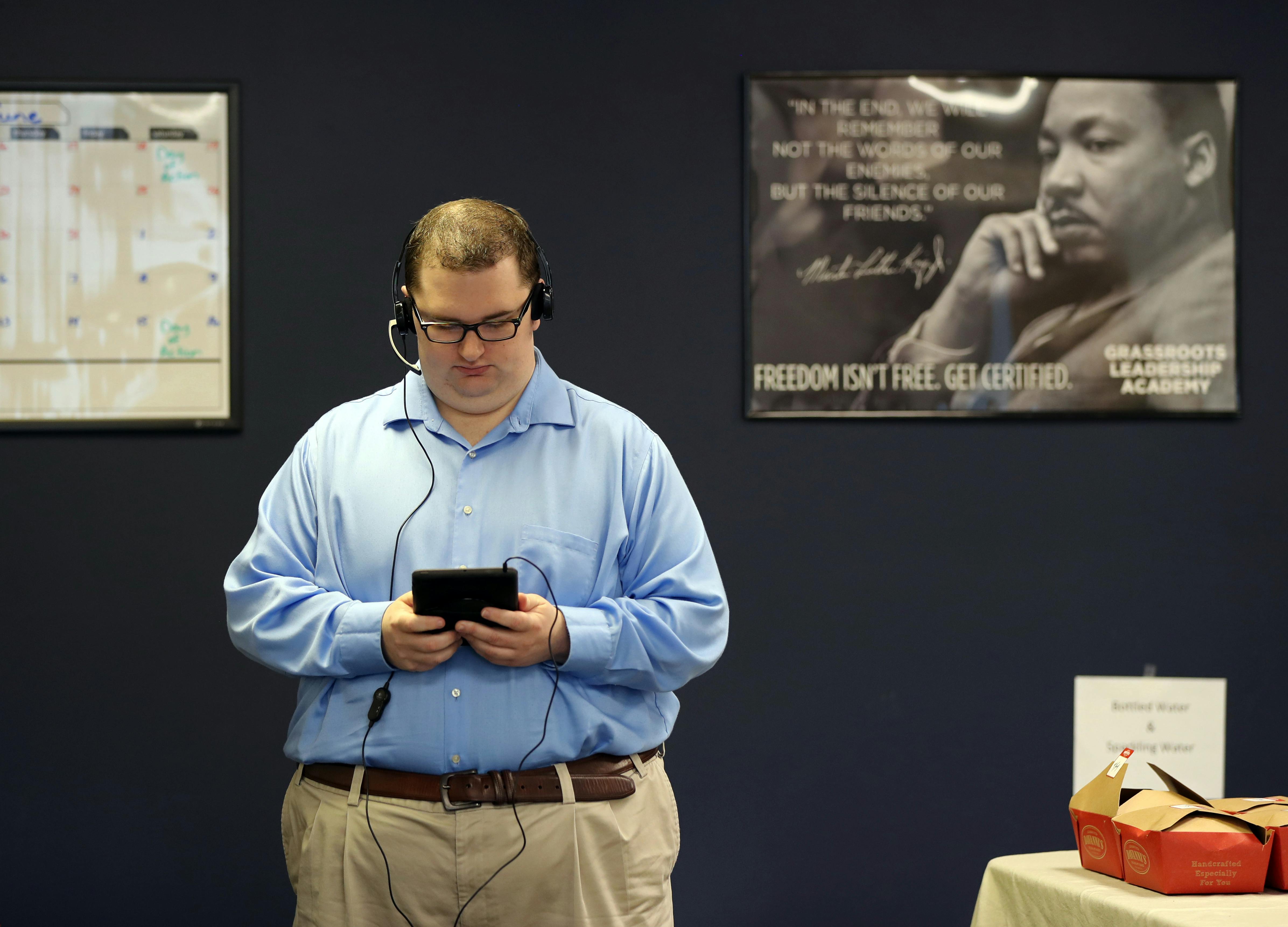 Inside the offices of Americans For Prosperity in Burnsville, people were busy making phone calls to Minnesotans to inquire about their opinions on topics like the recently passed tax bill and potential changes to Medicaid. Pat Kaluza from Lakeville made calls to Minnesotans through his handheld device.