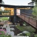 The Hansons' innovative sculptural home set in a Stillwater hillside features charred wood siding and an enclosed glass bridge. Their home was designe