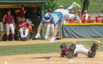 Heritage Christian Academy senior Seth Halvorsen goes airborne to avid the tag of Parkers Prairie catcher Brock Peterson. Despite the athletic play, H