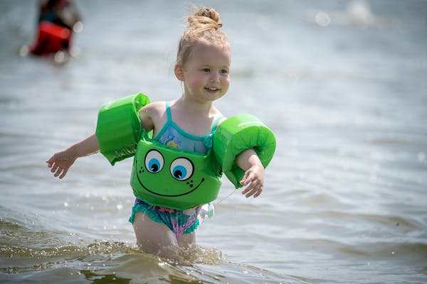 Adrielle Bedessem, 3, of Brooklyn Park showed her mother Delaine Bedessem how well she fared at swimming and keeping cool in a Lake Nokomis beach, Fri