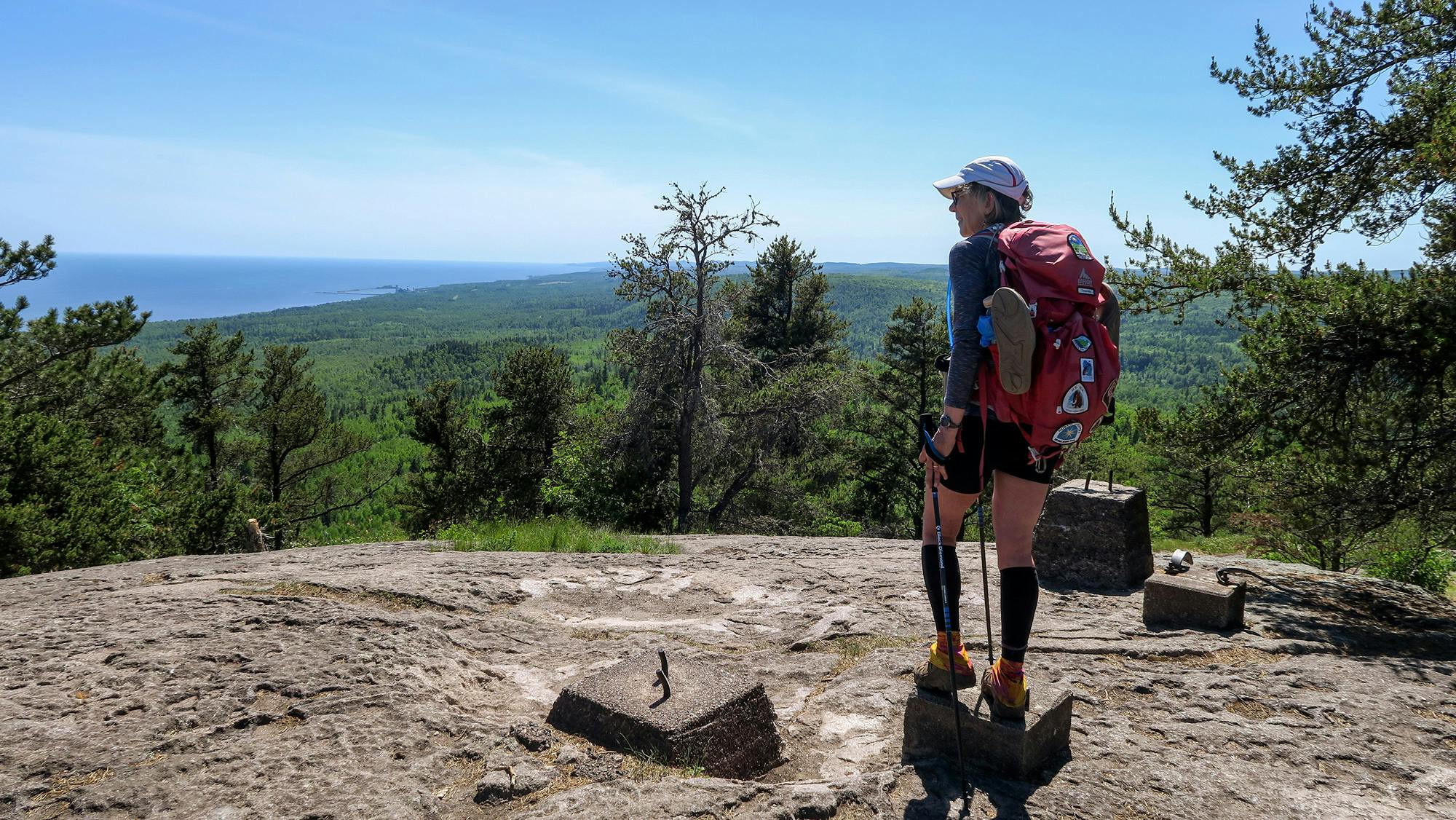 Melanie Radzicki McManus took in the view from the top of Carlton Peak, standing on footings for an old fire tower. Many of these high points along the North Shore are made of igneous rock, compositions of lava that gathered up and solidified millions of years ago.