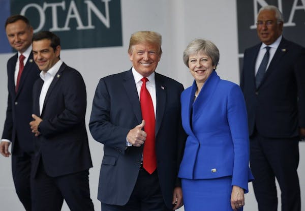 President Donald Trump, left, with British Prime Minister Theresa May, right, during a family photo at a summit of heads of state and government at NA