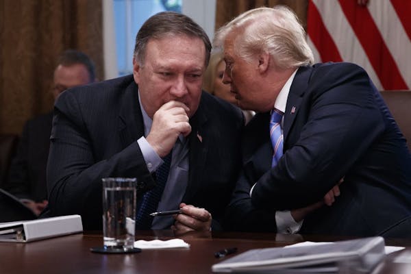 President Donald Trump speaks with Secretary of State Mike Pompeo during a meeting with his Cabinet on July 18, 2018, inside the Cabinet Room of the W
