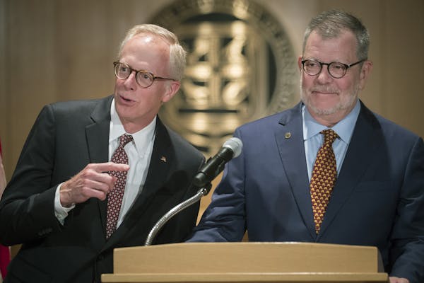 Board of Regents Chairman David McMillan, left, stood with University of Minnesota President Eric Kaler on Friday, when Kaler said he would leave his 