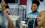 Thirteen-year-old hot dog entrepreneur Jaequan Faulkner, center, along with his cousin Destinee Grandberry, 12, left, cq, was all smiles after the cit