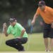 Robert Gamez, left, gave golfing tips to amateurs he was golfing with on the 16th green during the 3M Championship Pro-Am tournament on Wednesday at T