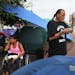 Yvonne, 32, sits in the makeshift camp just off of Hiawatha and Cedar Avenues as James Cross, founder of Natives Against Heroin, burns sage and prays.