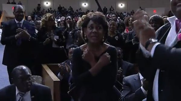 Maxine Waters stands and gives "Wakanda Forever" salute