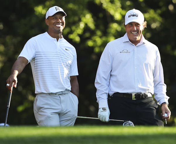 Tiger Woods, left, and Phil Mickelson enjoyed themselves while playing a practice round Tuesday for the Masters at Augusta National Golf Club.