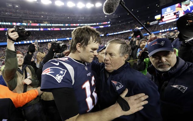 New England Patriots quarterback Tom Brady, left, hugs coach Bill Belichick after the AFC championship game against the Jacksonville Jaguars in Foxbor