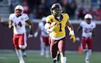 Minnesota's Rodney Smith (1) returns the opening kickoff for a touchdown during the first quarter during an NCAA college football game against Nebrask