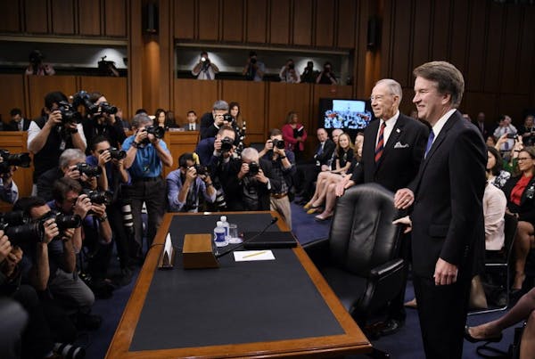 Supreme Court nominee Brett Kavanaugh takes his seat as he arrives to the first day of his confirmation hearings before the Senate Judiciary Committee