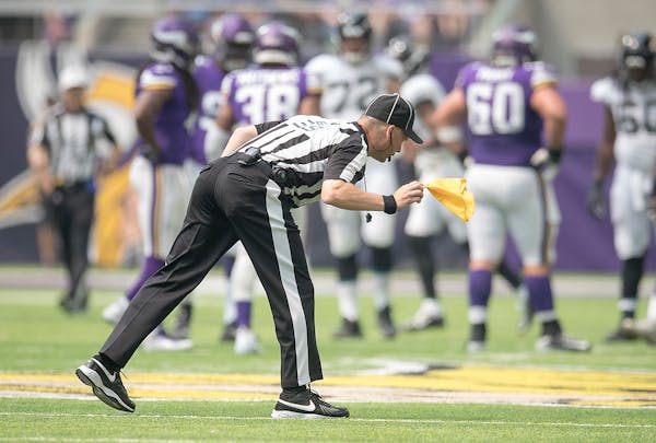 Back Judge Rich Martinez picked up one of the many penalty flags thrown as the Vikings took on the Jaguars in a preseason game.
