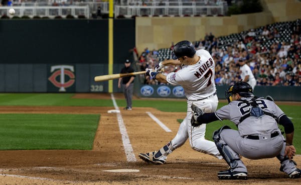 Joe Mauer crushed a decisive grand slam, capping a six-run fifth inning that put the Twins ahead 10-1 against the Yankees on Tuesday night at Target F