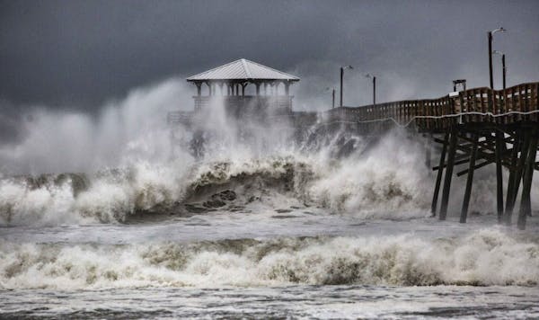 Waves slam the Oceana Pier & Pier House Restaurant in Atlantic Beach, N.C., Thursday, Sept. 13, 2018 as Hurricane Florence approaches the area.
