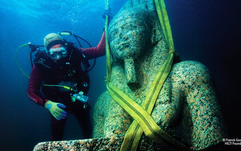 The bust of the colossal statue of Hapy, which weighs in at 9,700 pounds, before being cautiously raised out of the water of Aboukir bay, Egypt. It wi