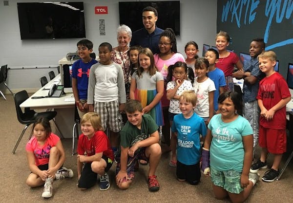 Tyus Jones, seen with students and staff of Westwood Elementary School.