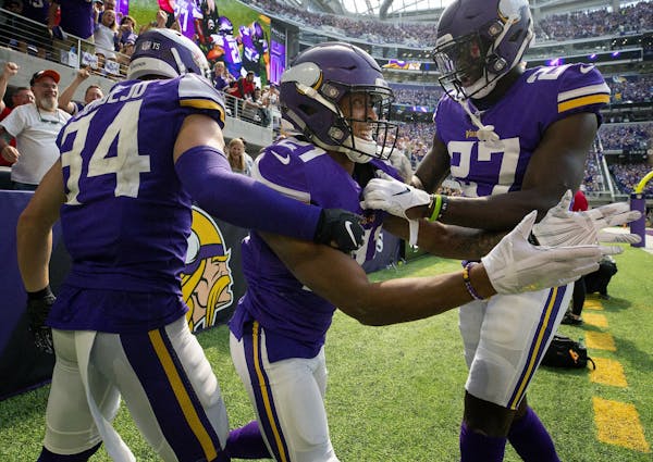 Mike Hughes (21) celebrated with teammates Andrew Sendejo and Jevon Kearse after returning an interception 28-yards for a touchdown in the third quart
