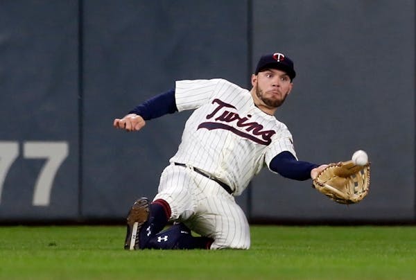 Twins left fielder Johnny Field makes a sliding catch of a fly ball off the bat of the Tigers' JaCoby Jones during the fifth inning Wednesday.