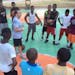 Matt McCollister, left photo, conducted a clinic in Zanzibar, an island off the coast of Tanzania. A young Tanzanian held a makeshift basketball. The 