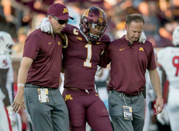 Minnesota's running back Rodney Smith is helped off the field after a first quarter injury as Minnesota took on Fresno State at TCF Bank Stadium, Satu