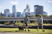 Jay Meekin and Steve Golat walked their dog Duffy on a walking path in the future home of a park next to the Graco factory with a view of downtown. Th