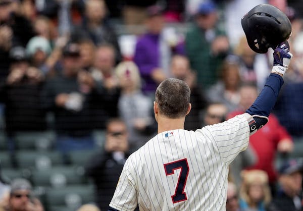 Minnesota Twins first baseman Joe Mauer tipped his hat to the cheering crowd before his first at bat on the final game of the season.