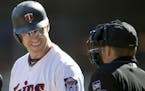 Twins first baseman Joe Mauer exchanged a smile with the umpire as he made his way to home plate to bat in the first inning as the Twins took on the C