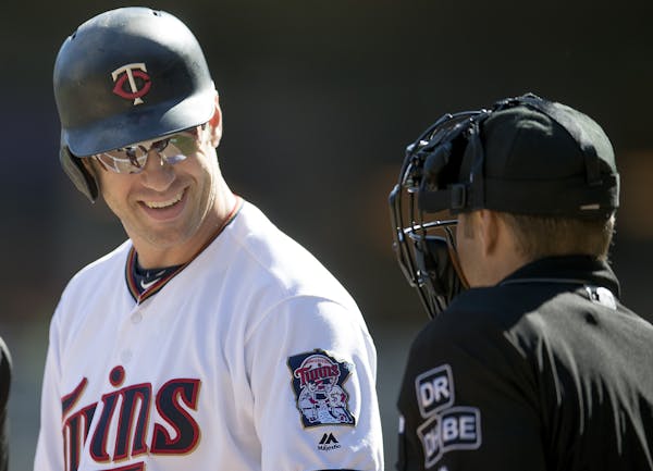 Twins first baseman Joe Mauer exchanged a smile with plate umpire Mark Wegner before coming to bat in the first inning of the first game of Friday’s