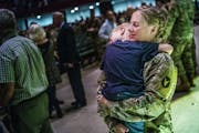 Capt. Stephanie Christoffels, a chaplain, held son David, 4, after Thursday's departure ceremony in St. Paul. She will be deployed for 10 months to Ku