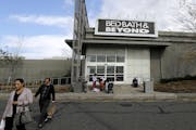 FILE- In this Oct. 25, 2017, file photo shoppers walk toward their vehicles outside of a Bed Bath & Beyond department store at Jersey Gardens Mall in 