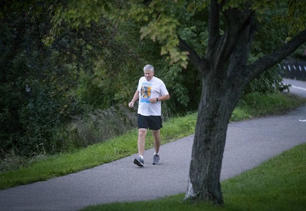 Mick Stephens made his way around Lake of the Isles during a morning run. Stephens, a longtime marathoner, had both knees replaced and is back on the 