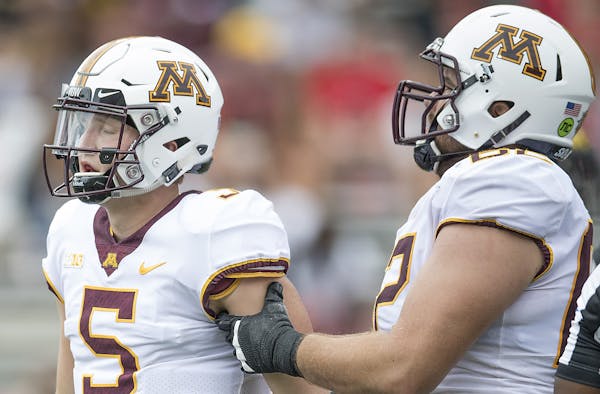 Gophers quarterback Zack Annexstad, left, struggled in his first Big Ten road start, going 14-for-32 for 169 yards, a TD and two picks.