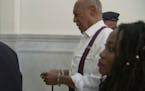 Bill Cosby, center, leaves the courtroom in handcuffs after he was sentenced to a three-to 10-year sentence for felony sexual assault on Tuesday, Sept