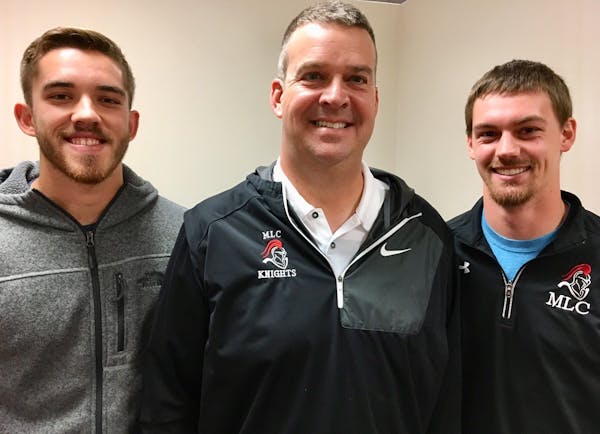 Martin Luther receivers Harrison Hochmuth, left, and John Arndt, right, flank coach Mark Stein.