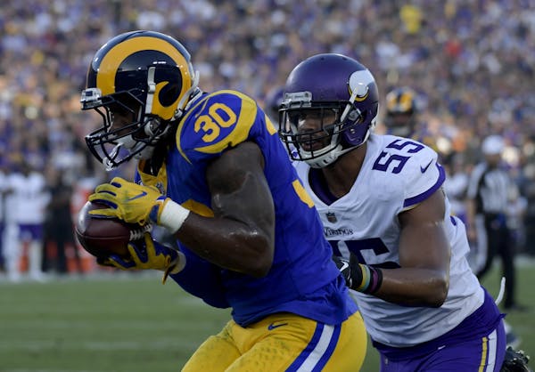 Los Angeles Rams running back Todd Gurley catches a touchdown pass in front of Minnesota Vikings linebacker Anthony Barr during the first half on Thur