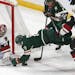 The Wild's Zach Parise, right, dives for the puck as Arizona goalie Darcy Kuemper reaches for it in the second period