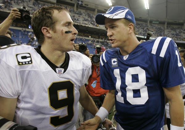 Drew Brees is 200 yards behing Peyton Manning (right) for the most passing yards in NFL history