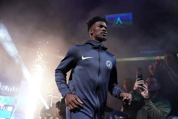 Timberwolves guard Jimmy Butler takes the court to a mixture of cheers and boos prior to action against the Cavaliers