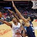 Clippers guard Tyrone Wallace, left, shoots as Timberwolves center Gorgui Dieng, center, and forward Keita Bates-Diop defend during the second half We