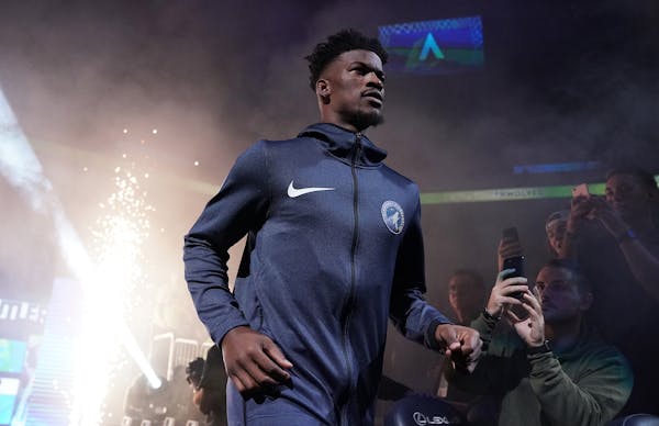 Jimmy Butler shown during Friday’s opening introductions, didn’t make the trip to Dallas on Saturday night, and won’t play the back end of back-