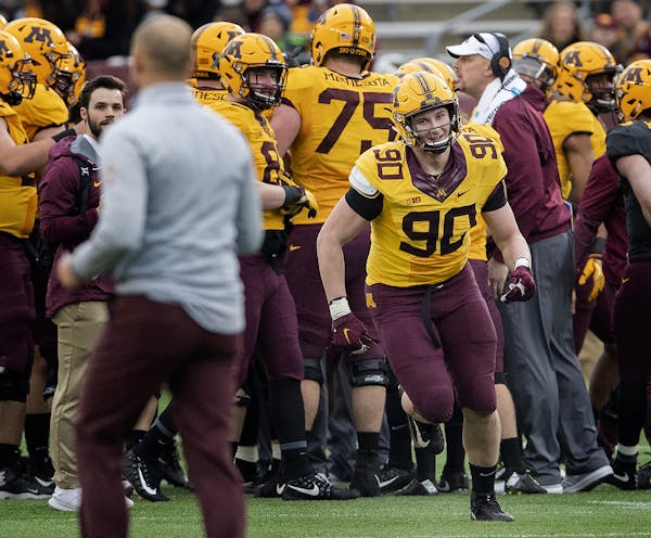 Sam Renner, one of two Gophers working on a master’s degree in accountancy, ran toward coach P.J. Fleck after being awarded a scholarship during the