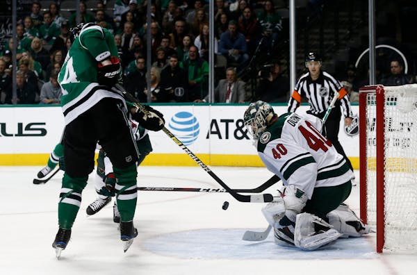 Dallas Stars wing Jamie Benn, right, is unable to shoot the puck past Wild goalie Devan Dubnyk during the first period