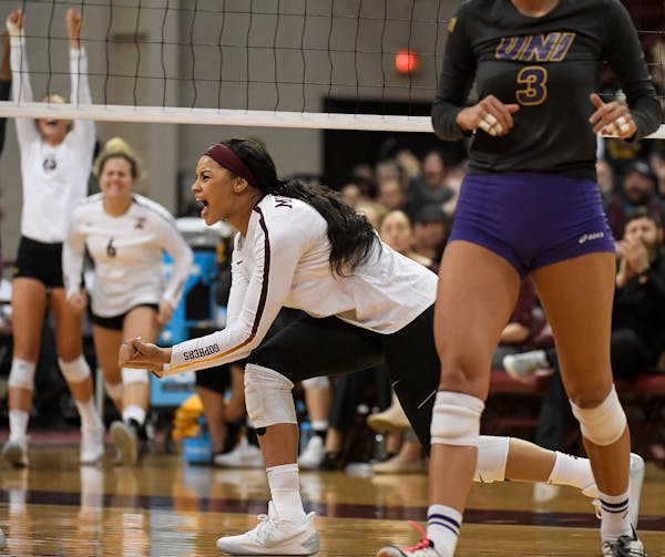 Minnesota outside hitter Alexis Hart (19) celebrated after scoring a point off a spike in the firs set against the University of Northern Iowa.