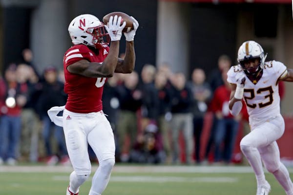 Nebraska wide receiver Stanley Morgan Jr. (8) makes a catch and runs for a touchdown in front of Minnesota defensive back Jordan Howden (23) during th