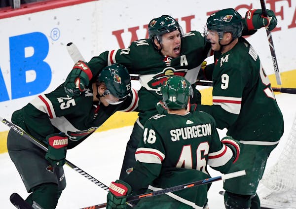 The Wild's Jonas Brodin (25), Jared Spurgeon (46), Zach Parise (11) and Mikko Koivu (9) celebrate a goal by Parise against the Tampa Bay Lightning
