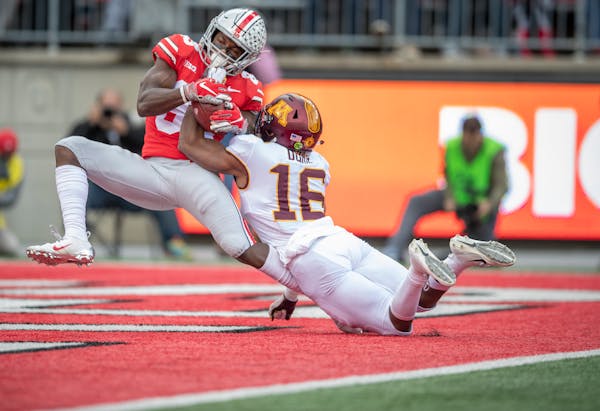 Ohio State wide receiver Terry McLaurin caught a TD pass despite the defensive efforts from the Gophers' Coney Durr during the first quarter Saturday.