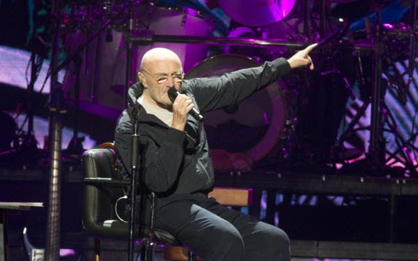 Back problems force Phil Collins to perform while seated on his Not Dead Yet Tour.