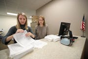 In 2018, election interns Haley Johnson (left) and Silence Marsh counted the petitions regarding St. Paul's garbage collection dropped off at the Rams