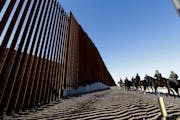 Mounted Border Patrol agents ride along a newly fortified border wall structure Friday, Oct. 26, 2018, in Calexico, Calif. (AP Photo/Gregory Bull)